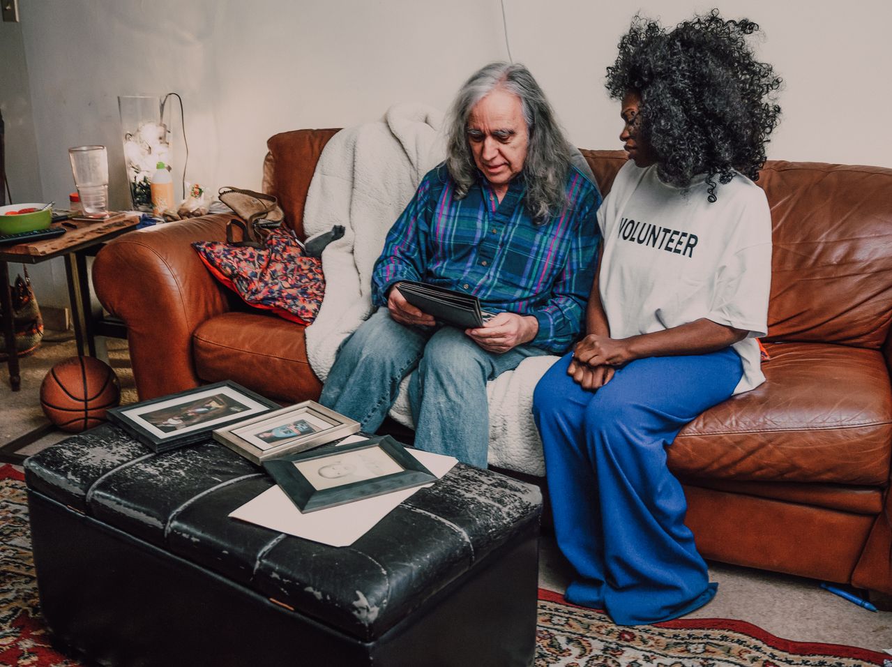Volunteer reading a book to a patient